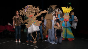 Teachers holding up cardboard characters they created during a CPD session at Gulbenkian