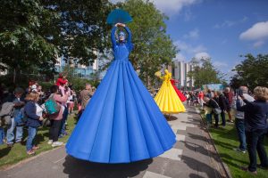 Giants in colourful dresses float across the campus
