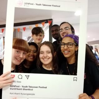 GENFest Young people posing in a cardboard Instagram frame