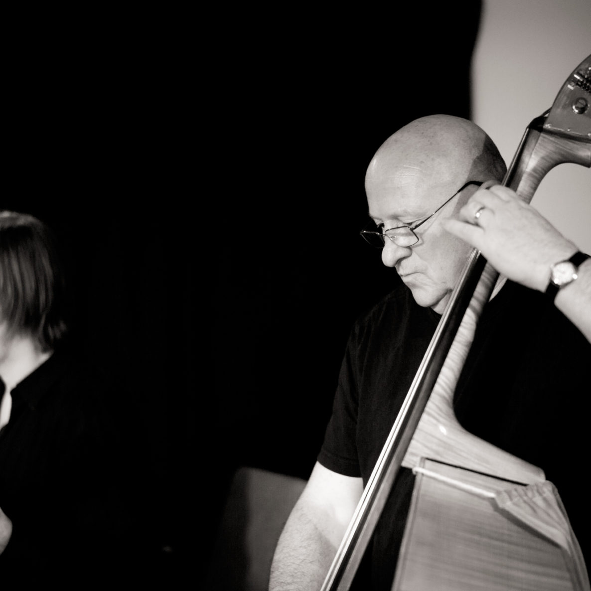 Gavin Bryars in profile playing a cello