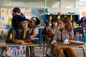 PJ and Posie stare at each other in horror in a crowded classroom